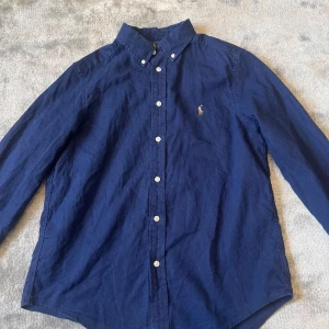 Mörkblå Ralph lauren skjorta - Mörkblå Ralph lauren skjorta i bra skick. Passar 15-16 år men skulle säga XS/S. bra pris köp snabbt!