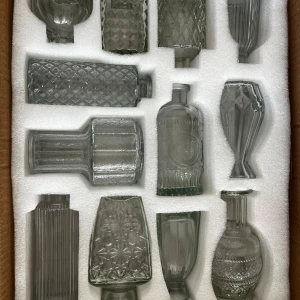 Set med tolv vintageinspirerade glasflaskor - Säljer ett set med tolv unika glasflaskor i olika former och mönster. Köpte två styckna till mitt bröllop men använde bara ett paket så de andra paketet jag säljer är helt oanvänd. 