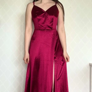 Rosaröd långklänning - Rosaröd långklänning i glansigt material med smala axelband. Perfekt för bal eller fest🥰 Har endast haft på mig en gång på skolbalen! Kan skicka bättre bilder om man vill se hela bättre :)