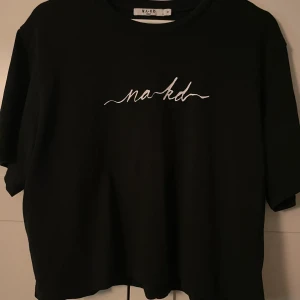 Svart t-shirt från NA-KD.  - Med en vit text över bröstet där de står NA-KD. Superskön tröja och använd max två gånger