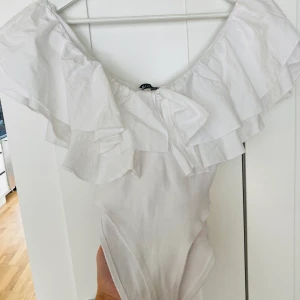 Body från zara  - Vit body från zara med volanger 🤍 älskar denna! Storlek M men passar riktigt bra som en S också. Slutsåld och i nyskick. Säljer denna då jag har två stycken. 