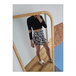 Mönstrad asymmetrisk kjol  - Abstrakt kjol med lite "omlottdesign" på framsidan. Köpt i New York för några år sedan. Häftigt, abstrakt mönster som går att matchas med mycket (ljusblå, mörkblå, grå, svart, vit, rosa etc.). Använd men i nyskick. Storlek: S, midja ca 35cm rätt över.