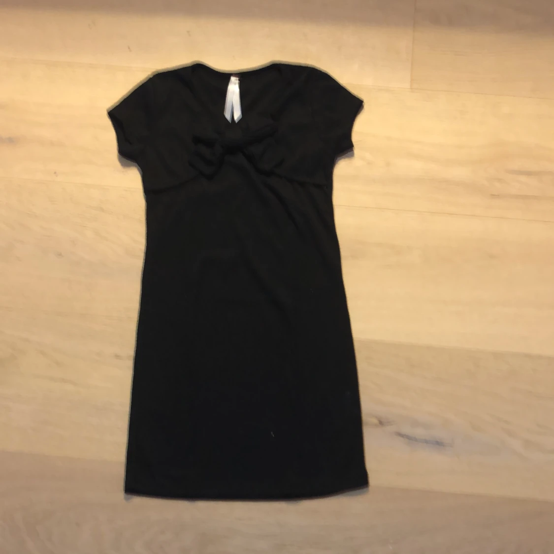 Svart klänning med en rosett