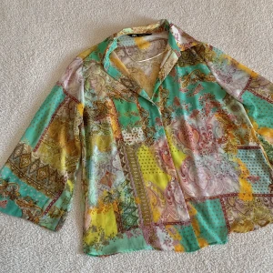 ZARA MÖNSTRAD FÄRGGLAD BLUS MED VIDA ÄRMAR - En fantastisk mönstrad skir blus med vida ärmar från ZARA. Är osäker på om jag vill sälja den. 🥹 Den är endast använd en gång och är i nyskick, utan anmärkningar. Svårt att få fram hur fin den är på bild. En riktig vårig färgsprakare 🌻