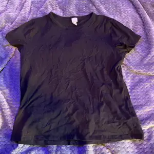 Svart t-shirt som jag nästan aldrig använt men den har krympt i tvätten så den e mer storlek M nu
