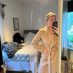 Beige kappa - Säljer denna oanvända kappan. Lagom lång och perfekt nu till hösten.  Nypris 799kr