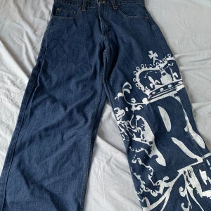 jeans med tryck - snygga baggy jeans med tryck. sitter bra i midjan på mig som är 165 och rätt bra i längden bara lite långa. lite är sönder vid byxbenen men inte alls mycket det är bara lite slitet. inte använt så mycket så bra skick. 