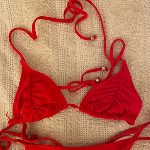 Röd scrunch bikini Nelly - Jättefin röd bikini med scrunch på underdelen, från Nelly.  Storlek S på toppen och storlek M på underdelen.