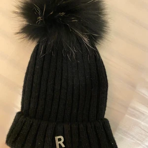 Rockandblue pom pom hat (äkta päls) - Säljer denna pom pom mössa från rockandblue som har äkta päls. Den är väldigt varm att ta på sig och även i väldigt bra skick. Den kostar 484 men säljer för 260.❤️Säljer via postnord eller så möts jag up i linköping😊Skickar även bevis innan jag postar .