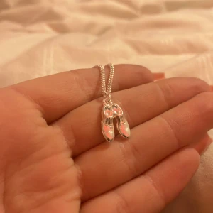 Silver halsband  - Ett silver halsband med ett par små söta skor 