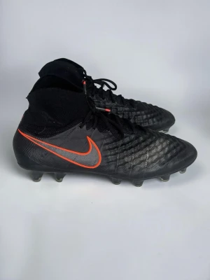 Nike magista Obra II - Nike Magista Obra II med Dynamic Fit-strumpkonstruktion i stilrent “blackout”-svart med kontrasterande orange Nike-swoosh. Flyknit-liknande vamp för snäv passform och maximal bollkänsla — playmaker-skon för dig som styr spelet.  ✅ FG-dobbar (Firm Ground) – för naturgräs ✅ Storlek: 42 ✅ Skick: Använda, bra skick  Magista är designad för mittfältare/playmakers som vill ha kontroll och touch. Skickas snabbt och säkert med spårbar frakt 📦  Fråga gärna vid funderingar innan köp!  #Nike #Magista #Nike