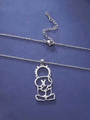 Palestina Handala Silverfärgat halsband med konstnärlig berlock - Unikt halsband i silverfärgad metall med en konstnärlig, utskuren berlock som föreställer en sittande figur med korsade armar. Kedjan är tunn och har ett klassiskt lås. Perfekt för dig som gillar statement-smycken med modern design.