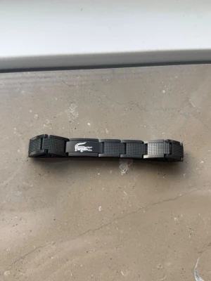 Lacoste armband  - SVART Lacoste armband storlek 20cm (går lätt att fixa hemma till 18cm) Skick 8/10