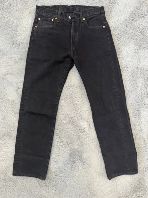 Levis’s 501 - Säljer ett par svarta Levi’s 501 Regular Fit i fint skick. Klassisk passform med snyggt tvättad svart färg. Bekväma och enkla att matcha till det mesta.  W: 30   L:30 Inga hål eller större skador. Säljes då de inte kommer till användning.