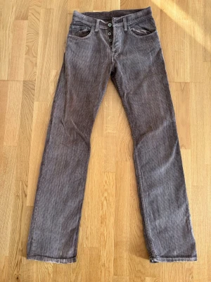 Casucci Manchesterbyxor W29 L32 – brun - Bruna manchesterbyxor från Casucci med raka ben och klassisk femficksmodell och lite retro. Tydlig manchesterstruktur och knappgylf. Passform som Diesel Regular Larkee, med raka och något rymligare ben.  Använda men i fint skick. Inga hål eller fläckar.  Storlek: W29 L32 Passform: rak modell Skick: 7/10