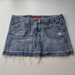 Jeanskjol mini - Bild 3 visar färgen bäst! En härlig liten 2000-tals jenaskjol! Midjemått: 86cm längd: 28cm 🥰