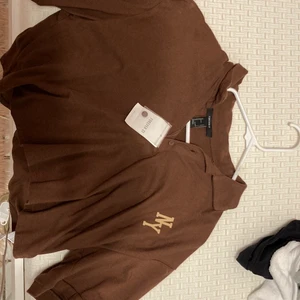 Mocha collar crop top t-shirt - Hello shoppers I’m selling this mocha crop top collar shirt with graphic letters if would like to make a reasonable offer please do so. It’s also brand new.😊