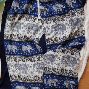 Royal Elephant men/women Harem Pants - Super comfortable light weight soft, draw string harem/Genie, casual, double stitched pants, fits all body types. Each pair is unique and may slightly vary from the picture.  Waist 24-44" - 57 cm to 108 cm  Hip 54 - 138 cm  Length 41" - 105 cm  100% Rayon