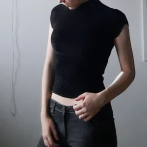 Black textured top  - Tight fit , shiny , good condition