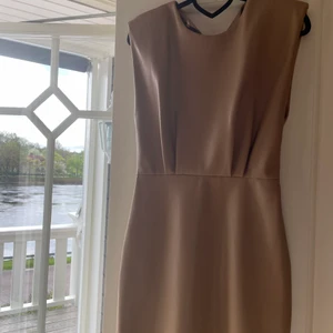 Klänning  - En mycket fin beige fake leather klänning. Helt oanvänd men etiketten kvar. 