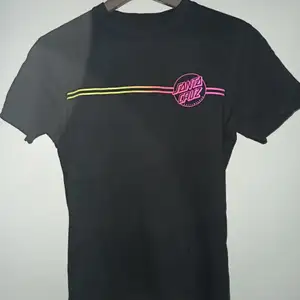 En svart Santa Cruz t-shirt med print. Tröjan är i mycket bra skick då den inte kommit till användning särskilt ofta. 