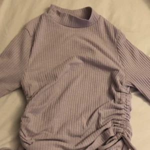 Lila långärmad tröja - Ljuslila långärmad tröja med snörning på sidorna från new yorker kostade ca 150 när jag köpte den:)