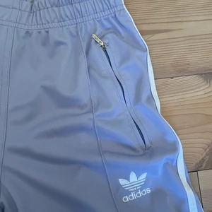 Adidas byxor - Lila Adidasbyxor i storlek M (första två bilderna är lite missvisande i färgen, kolla bild 3). Snygga och bra kvalitet, säljs pga för korta för mig (jag är ca 1,75 cm).