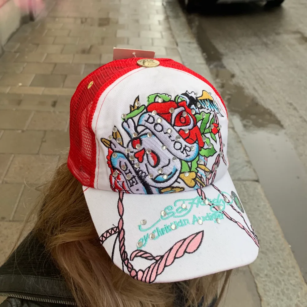 Helt ny röd+vit Ed Hardy keps med en döskalle. Prislapp och skydd på insidan kvar. Jätte cool och snygg till sommaren. Köparen står för frakt. Buda från 150kr⭐️. Accessoarer.