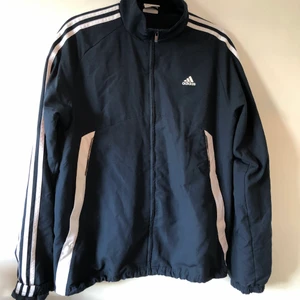 Adidas träningsjacka - Mörkblå tunn adidas träningsjacka som inte kommer till användning längre. Herr storlek large så armarna är ganska långa men är snyggt att vika upp dom också. 