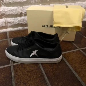 Axel Arigato skor  - Säljer mina ”Clean 90 Tape Bird” i storlek 41 ifrån Axel Arigato då de tyvärr inte kommer till användning. Dom är använda max 5 gånger och är i väldigt bra skick. Man får med skokartongen samt en dustbag ifrån Arigato. Köpte dom för 2000kr. Frakten tillkommer💗 Priset kan diskuteras. 