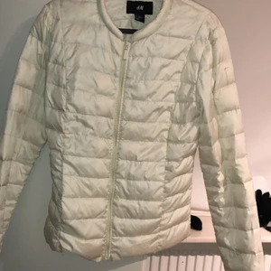 Vit dunjacka  - Dunjacka för alla. Perfekt inför hösten och våren. Fickorna har ej kedja eller knapp och har ingen luva. Jackan är i storlek XS men passar även S