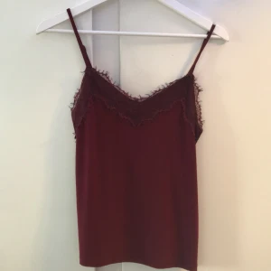 Spettslinne - Säljer en vinröd spetslinne 