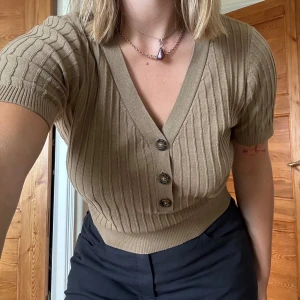 Brown/beige top - Short sleeved buttoned up top. The tag is cut off but I think the size is S/M