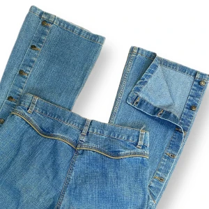 Y2K Jeans  - Cute mid rise/high rise Y2K cowboy jeans in good condition 🤠🤎  Buttons along the calves, unbuttoned picture seen in picture three. Size 40  Measurements:Waist width 41cm, Crotch depth 25cm, Hip width 46cm & Inner leg length 75cm