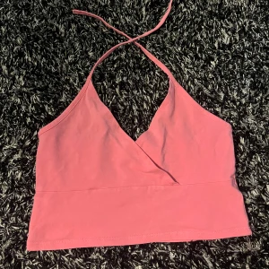 Rosa linne - Ett rosa linne som använd fåtal gånger. Knyter banden bakom nacken. Perfekt för fest eller varför inte en somrig sommardag. Kvaliten är bra