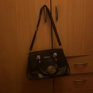 Svart väska - Säljer denna väska kommer inte till användning då jag använde bara när jag gick i grundskolan ganska mycket men inte längre så den har bara varit hängd i flera år då jag inte vill ha denna så det är inget fel på den den så i fint skick!😊