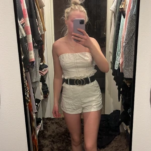 Playsuit  - Blixtlås i ryggen och breda hällor i midjan. 