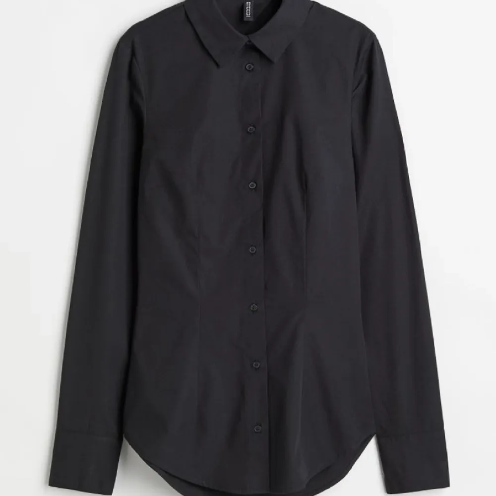 En svart skjorta från H&M med öppen rygg. Använd endast 1 gång.  Den sitter tight i midjan då det finns ett snöre man knyter i ryggen.. Skjortor.