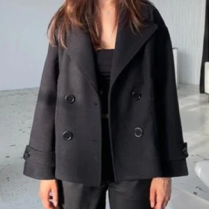 Design by Si Kappa - Säljer den svarta populära kappan från Design By Si. Den köptes förra året och jag känner att den har gjort sitt så därför säljer jag den🥰 Superfin kappa som passar till alla outfits 😍 Storlek XS/S  Nypris 757 men säljer för 450kr