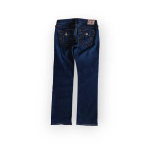 True Religion jeans Billy big T - Mörka raka true religion jeans, bra skick. Uppsydda längst ned men det syns inte och går att sprätta upp om man vill ha längre. Storlek 29 passar 34-36 ungefär. Fråga gärna om mått eller fler bilder 💕
