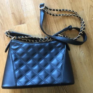 Väska  - En jätte fin väska och rymmer mycket, sälj pga den kommer inte kommer till användning, använd få tal gånger finns fack inuti också, fint med guld detaljer