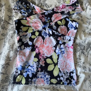 Blommig topp  - Säljer denna blommiga toppen i lite tjockare tyg, off shoulder ish
