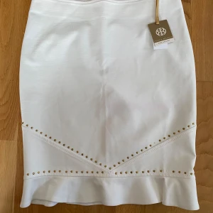 Ny vit kjol från Cecilia Bolocco Para Apology i strl 44 - Ny vit kjol från Cecilia Bolocco Para Apology i strl 44.  Ny med prislappen kvar   Mått Midjan: ca 41 cm Längd: ca 55 cm  59% rayon, 36% nylon och 5% elastan