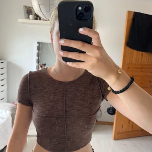 Brun t-shirt - Brun croppad t-shirt från h&m/divided. Tyget är väldigt mjukt och stretchiga samt melerat i olika toner av brunt. Passar även stl. S! Utstickande sömmar. Använd endast ett fåtal gånger🤎