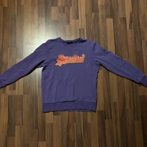 Superdry tröja med tryck - Lila Superdry tröja med tryck. Väl använd men i mycket bra skick. Säljes pågrund av för liten. Storleken är eu40