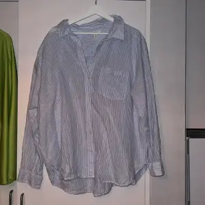 En blå/vit randig skjorta från HM. Säljes då den aldrig är använd. 