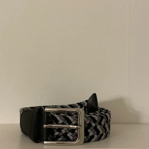 Flätat bälte - Säljer nu detta riktigt snygga flätade bälte som är i super bra skick! Färgerna är svart, mörkgrå och ljusgrå och storleken är 105cm. Hör gärna av dig vid frågor eller funderingar😃