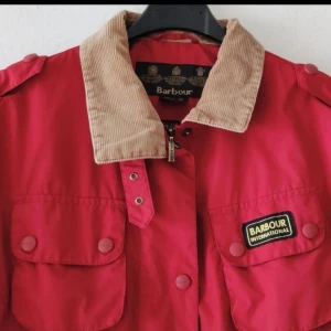 Ultralätt jacka från den engelska Barbour - Ultralätt jacka från den engelska Barbour-kollektionen.  Klassisk skärning … en tidlös klassiker Finaste kvalitet högsta utförande Mycket bekväm att bära  Storlek: 42 (UK 16) Bröstvidd: 60 cm Axelbredd: 45 cm Längd: 72 cm Ärmlängd: 61 cm