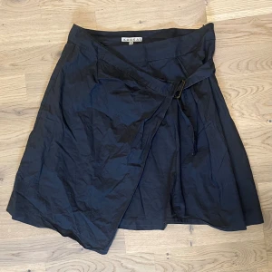 Futuristic Kjol - Kjol med knytning. Midjemått tvärsöver är 38 cm och totala längden är 47 cm.