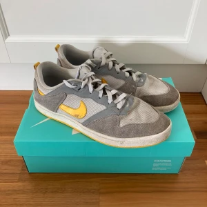 Nike SB Alleyoop sneakers  - Nike SB Alleyoop sneakers för män. Skick: Använda. Storlek: 42,5. Färg: Grå/gul/vit. Obs, olika färger på skosnörena (vita och gråa). Meddela gärna mig för mer info & bilder!